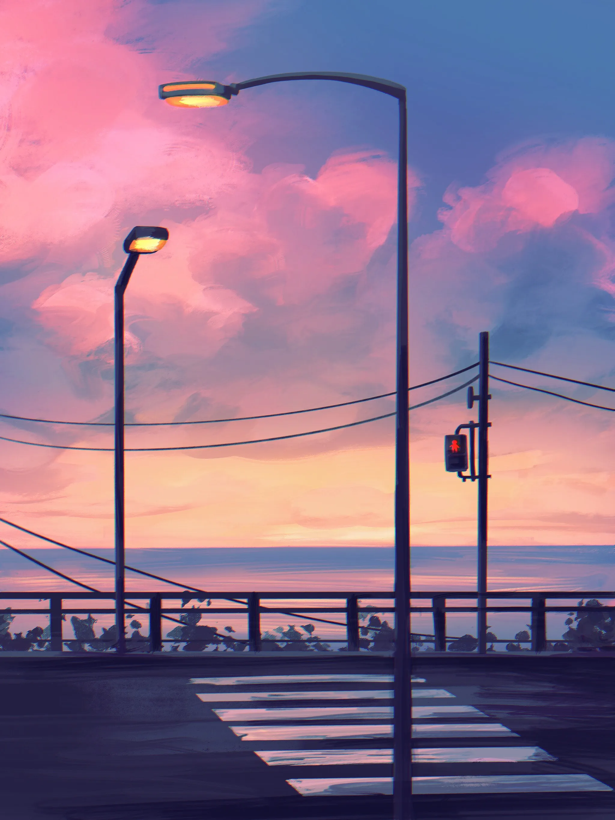 Pink clouds and palm trees above a seaside road at dusk.